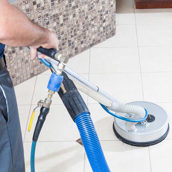 Man Cleaning Tile and Grout